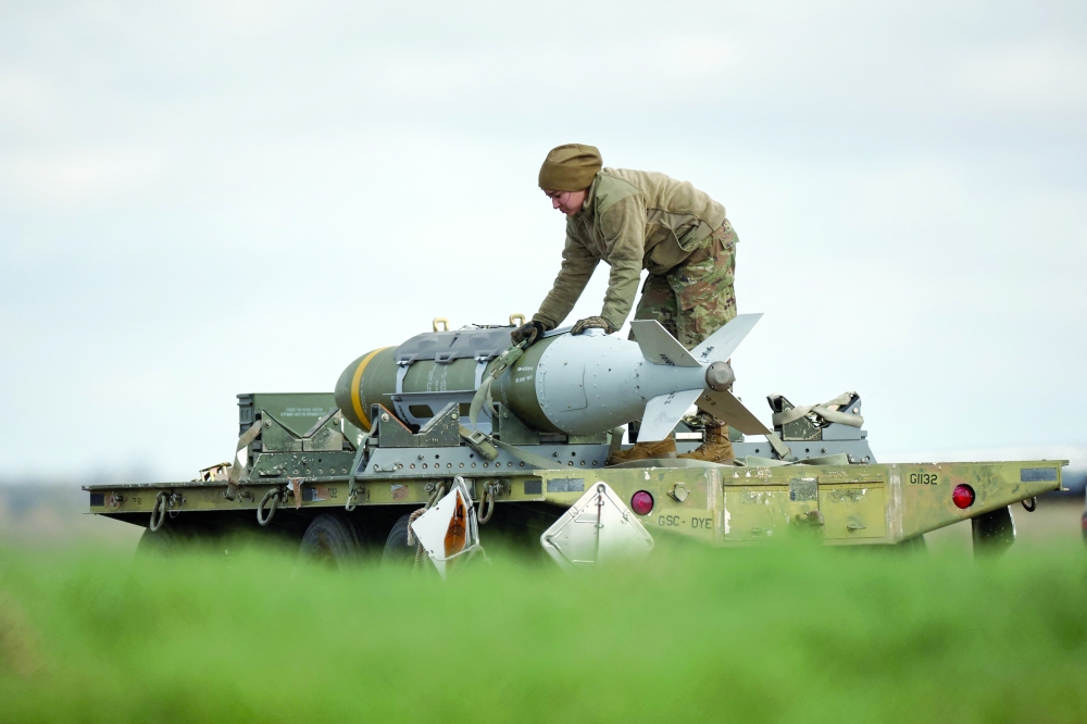 Joint Direct Attack Munitions are taken away having been removed from a US Air Force B-1 Lancer bomber at RAF Fairford in south-west England. — AFP