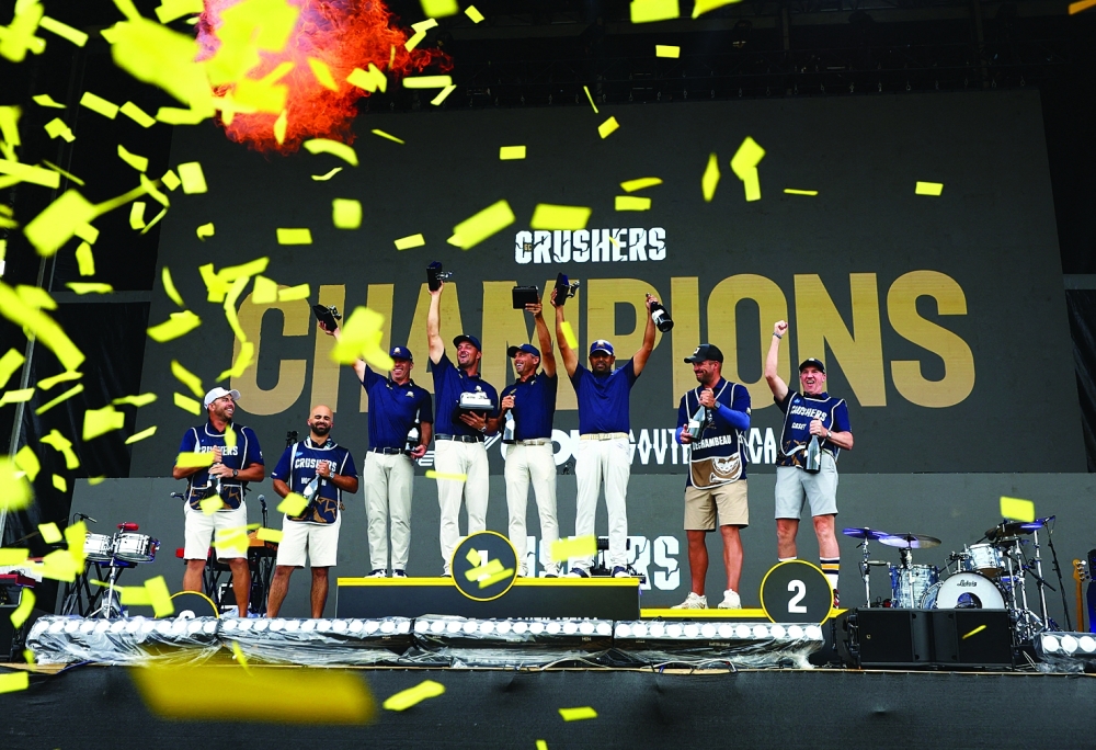 Crushers GC's Bryson DeChambeau, Paul Casey, Charles Howell III, Anirban Lahiri, and caddies celebrate on the podium after winning the LIV Golf South Africa team event. — Reuters