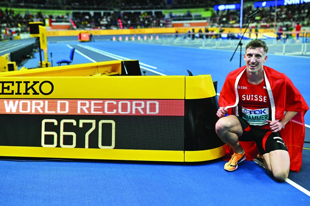 Switzerland's Simon Ehammer celebrates winning and setting a new world record after competing in the men's heptathlon 1000m final during the World Athletics Indoor Championships Kujawy Pomorze 2026 in Torun, Poland on March 21, 2026. (Photo by Andrej ISAKOVIC / AFP)

