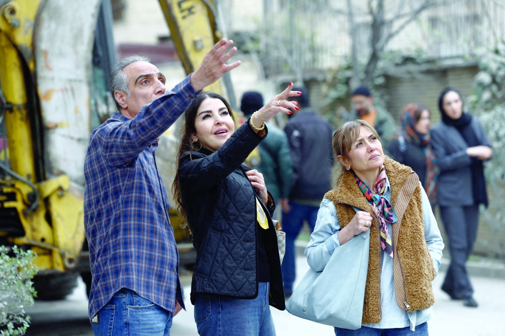 People look at the damage at the site of a strike on a residential building in Tehran, Iran, on Monday. — Reuters