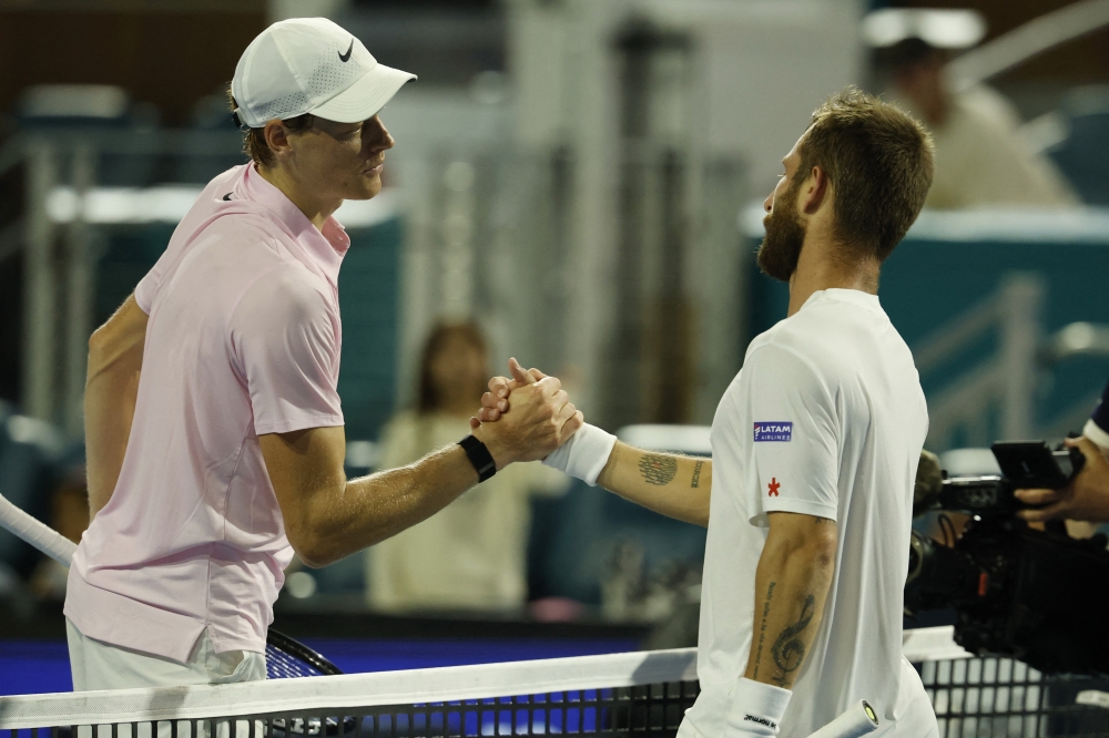  Jannik Sinner (ITA) (L) shakes hands with Corentin Moutet (FRA) (R) at the net  