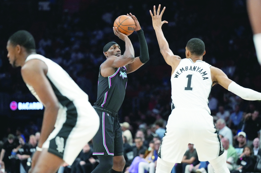 Miami Heat centre Bam Adebayo (13) takes a shot over San Antonio Spurs forward Victor Wembanyama (1) during the first half at Kaseya Center. — Imagn Images
