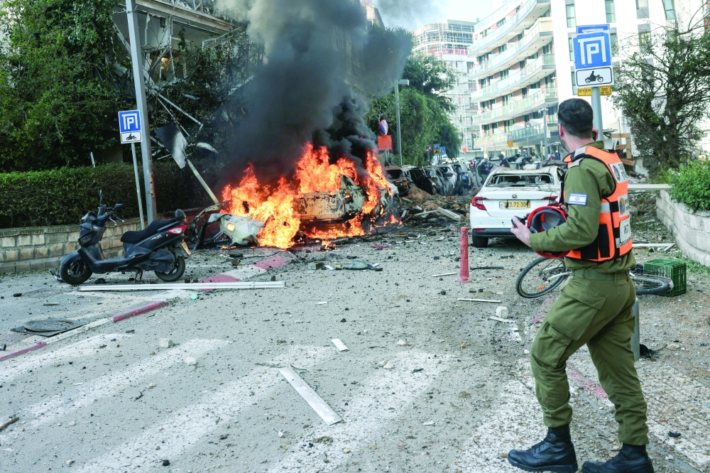 An emergency worker walks at a site following Iranian missile barrages in central Israel. — Reuters 