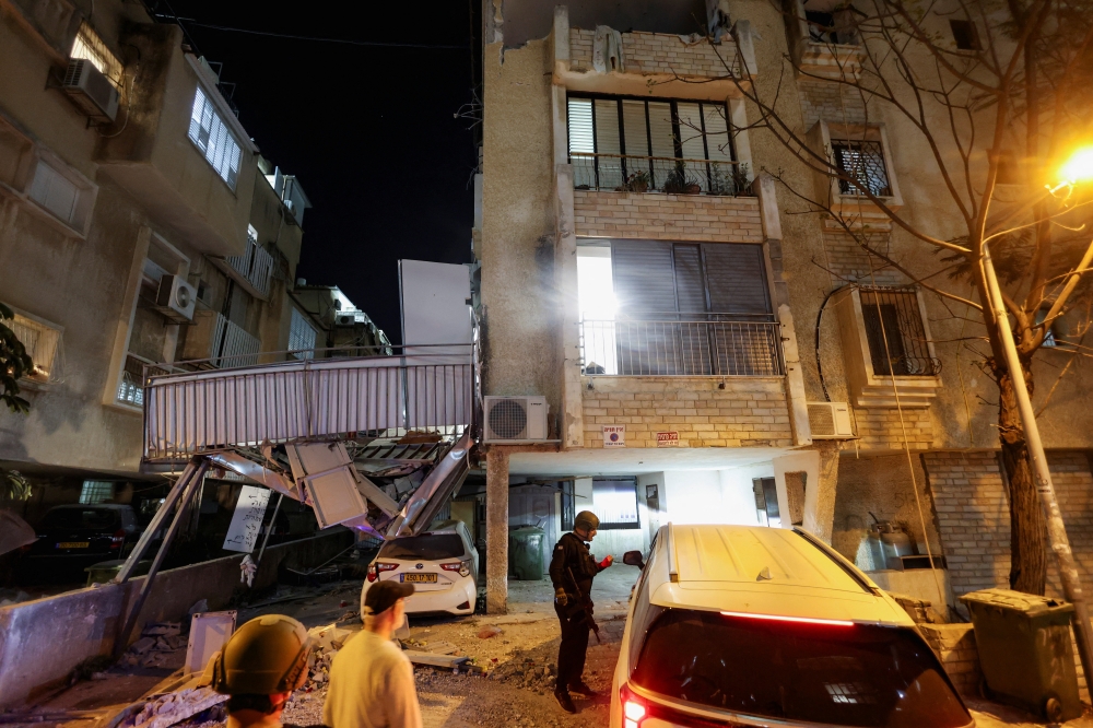 Emergency personnel respond following Iranian missile barrages in central Israel