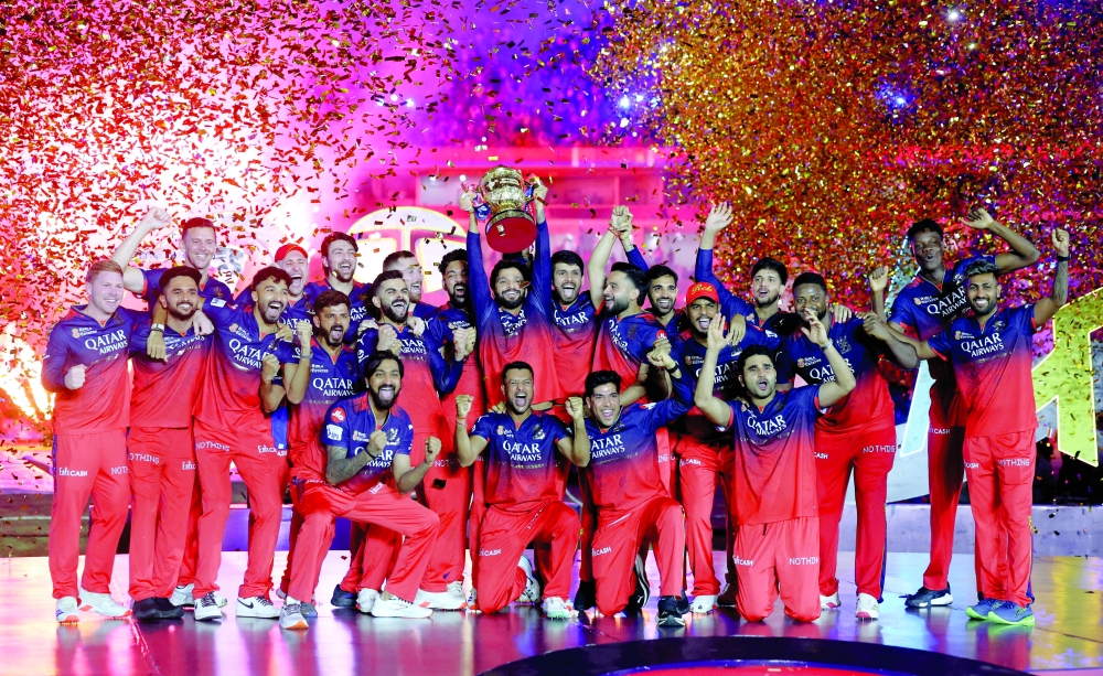 Royal Challengers Bengaluru players celebrate with the trophy after winning the Indian Premier League 2025. — Reuters