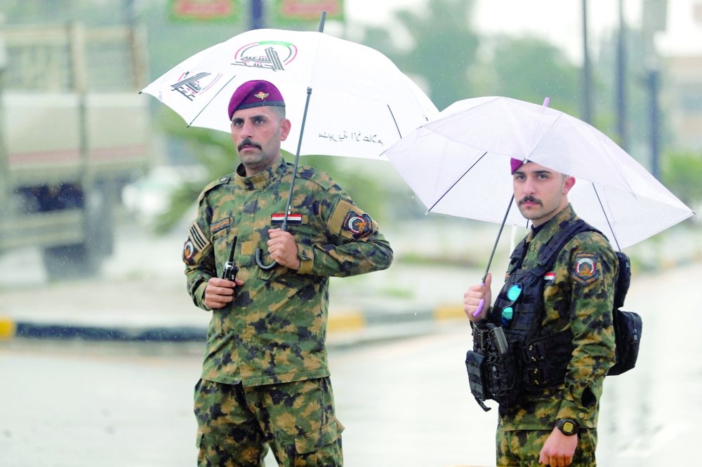 Soldiers guard the streets during the funeral for members of forces in Baghdad. — AFP