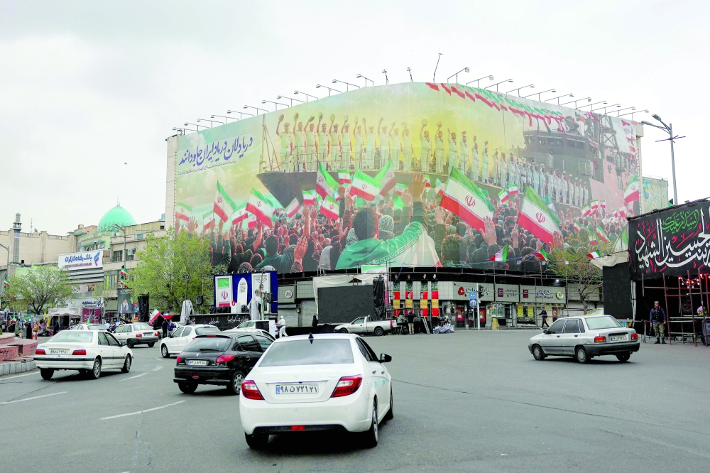 Vehicles move along Enghelab Square in central Tehran. — AFP