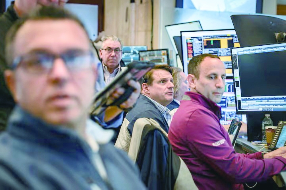 Traders work on the floor at the New York Stock Exchange (NYSE) in New York. REUTERS