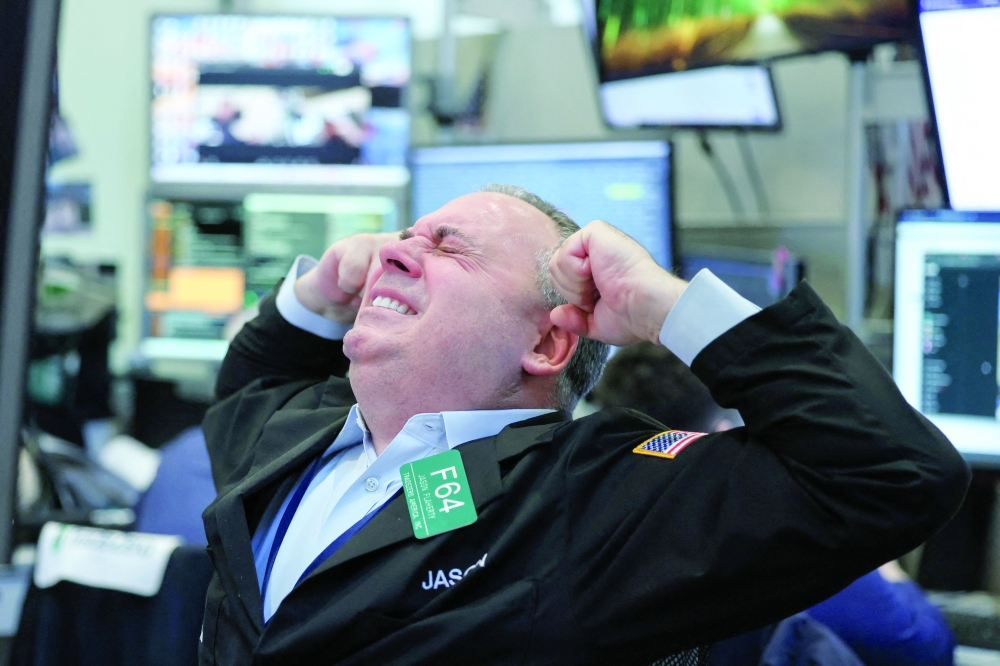 A trader on the floor of the New York Stock Exchange at the opening bell in New York. - AFP