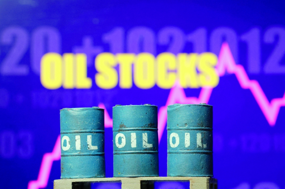 3D printed oil barrels, rising stock graph are seen in this illustration. - Reuters  