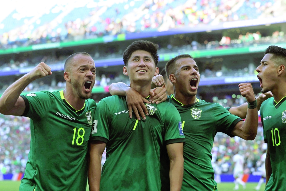 Bolivia's forward #07 Miguel Terceros (2nd L) celebrates with teammates midfielder #18 Juan Godoy (L), midfielder #14 Robson Matheus and forward #10 Ramiro Vaca after scoring a penalty kick during the 2026 FIFA World Cup qualifiers semi-final playoff football match between Bolivia and Suriname at the BBVA Stadium in Guadalupe, Mexico on March 26, 2026.  (Photo by Julio Cesar AGUILAR / AFP)
