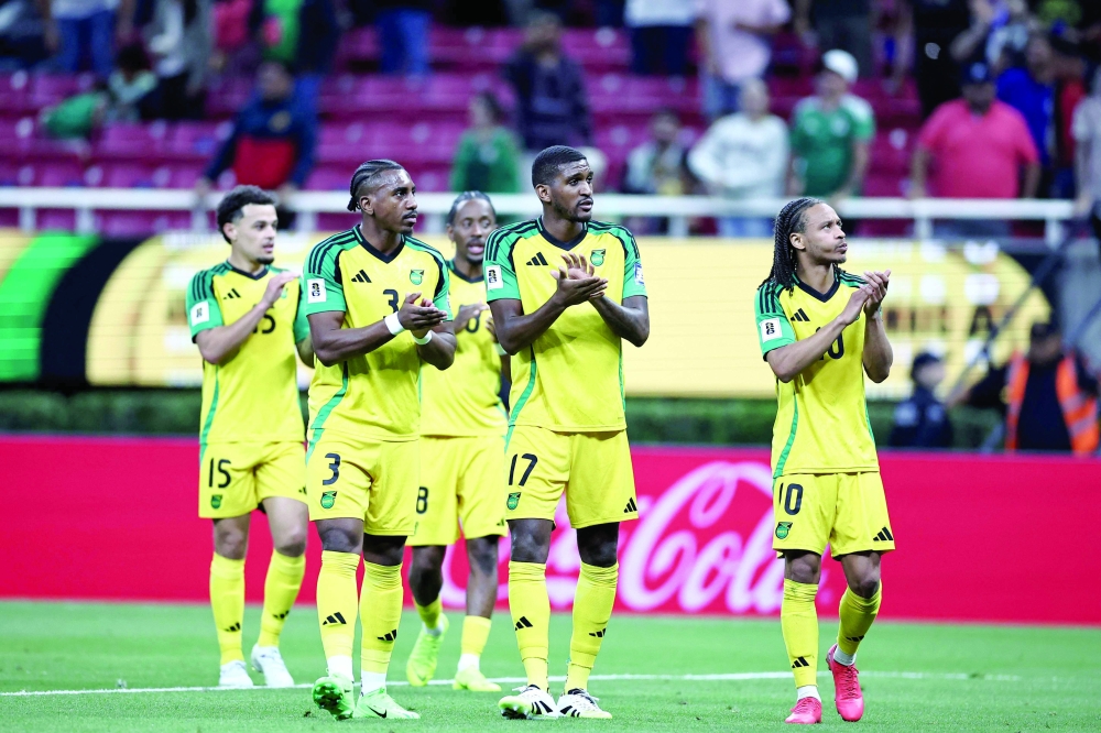 Players of Jamaica celebrate after winning the 2026 FIFA World Cup qualifiers semi-final playoff football match between New Caledonia and Jamaica at the Akron Stadium in Zapopan, Mexico on March 26, 2026.  (Photo by Ulises Ruiz / AFP)
