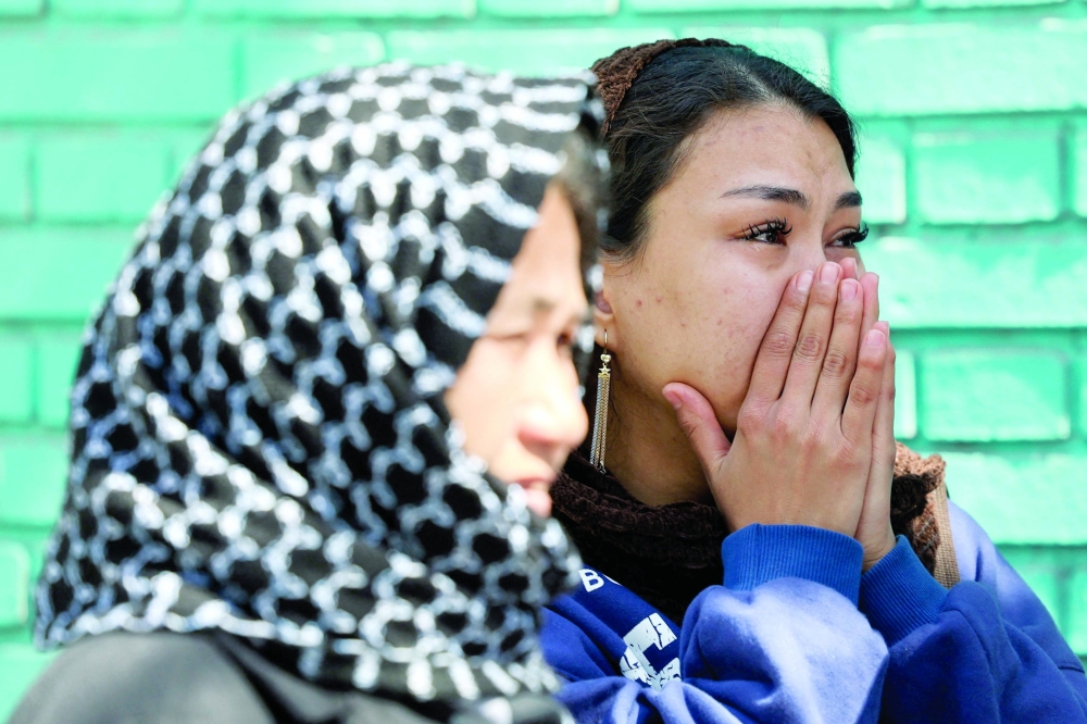 A woman reacts next to the site of a residential building damaged by a strike, amidst the US-Israeli conflict with Iran, in Tehran. — Reuters
