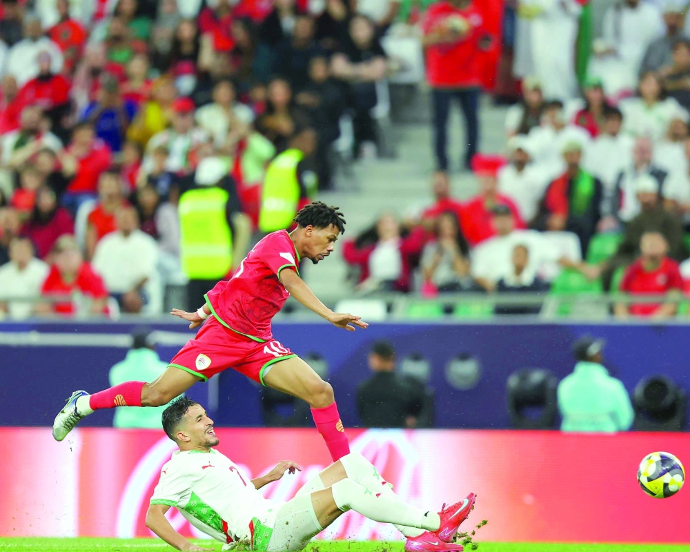 A shot of player Jamil al Yahmedi attempting to get past a Moroccan defender during the Arab Cup tournament.