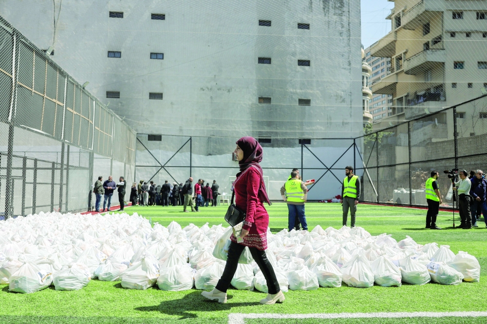Aid groups distribute food and basic supplies to displaced families, in Beirut. — Reuters