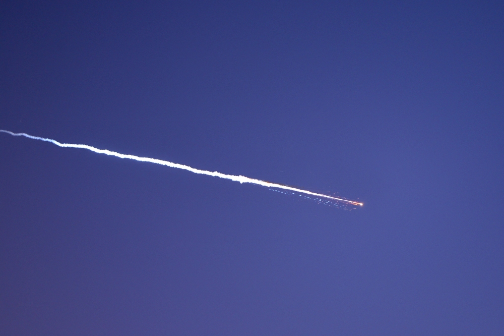 Rocket trails are seen in the sky above the Israeli coastal city of Netanya amid a fresh barrage of Iranian missile attacks on March 28, 2026.