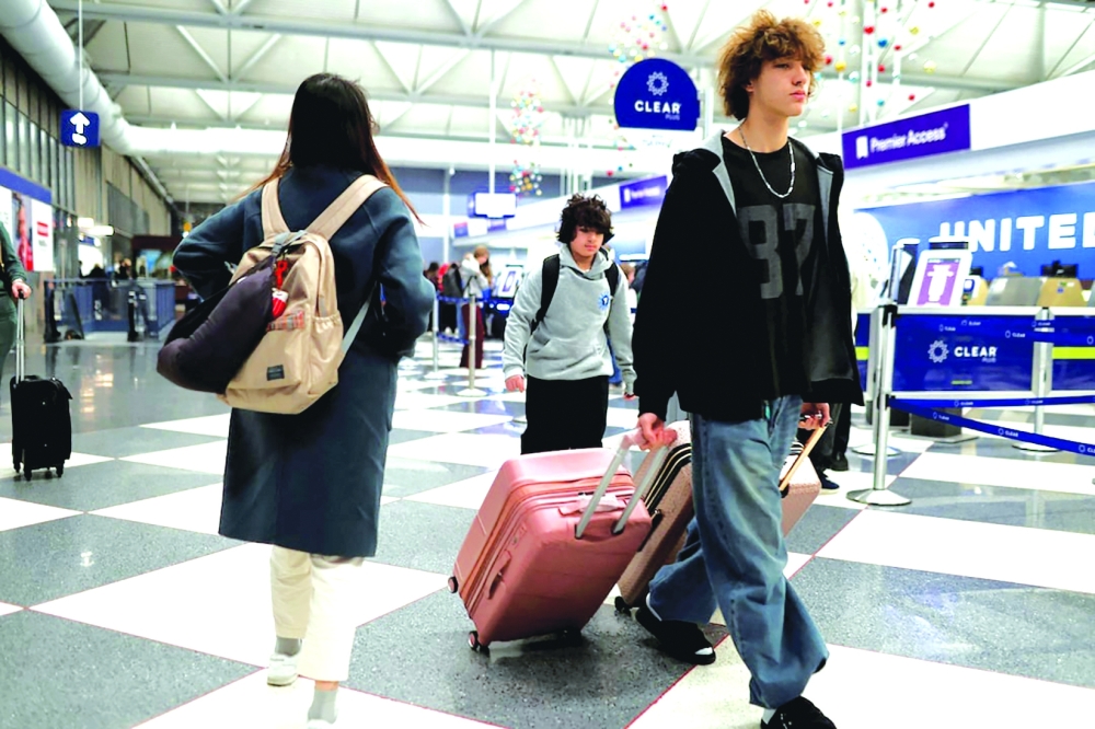 Passengers walk to board flights at Chicago O'Hare International Airport in Chicago, Illinois. — Reuters