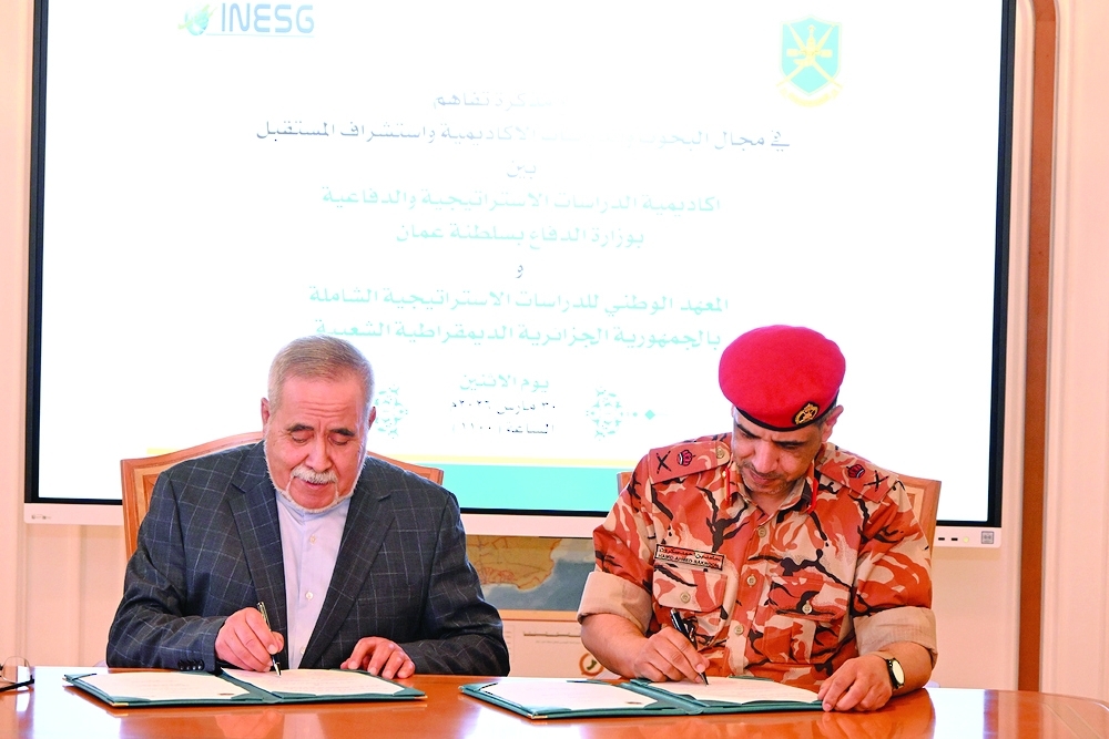 Maj Gen Hamid bin Ahmed Sakroon and Abdelaziz Medjahed signing the MoU.