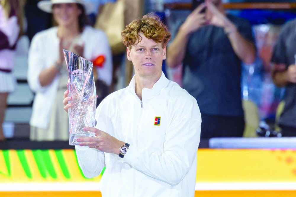 Jannik Sinner of Italy poses with the Butch Buchholz Championship Trophy after defeating Jiri Lehecka of the Czech Republic in the final of the Miami Open. — Imagn Images