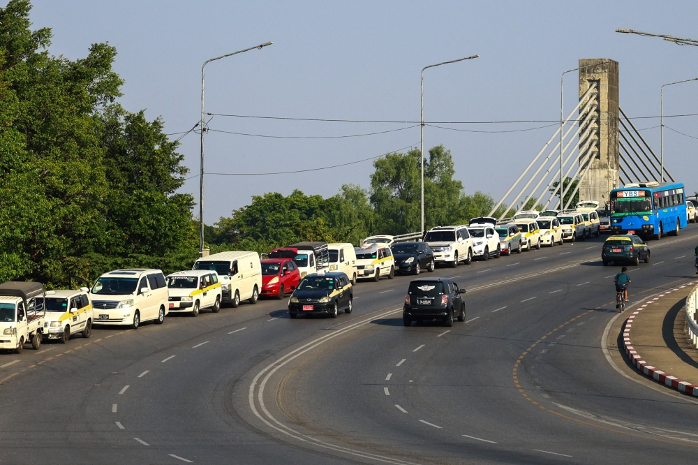 Vehicles queue to fill gasoline outside a gas station amid fuel shortages linked to the U.S.-Israeli war on Iran, in Yangon, Myanmar, March 27, 2026. REUTERS/Stringer