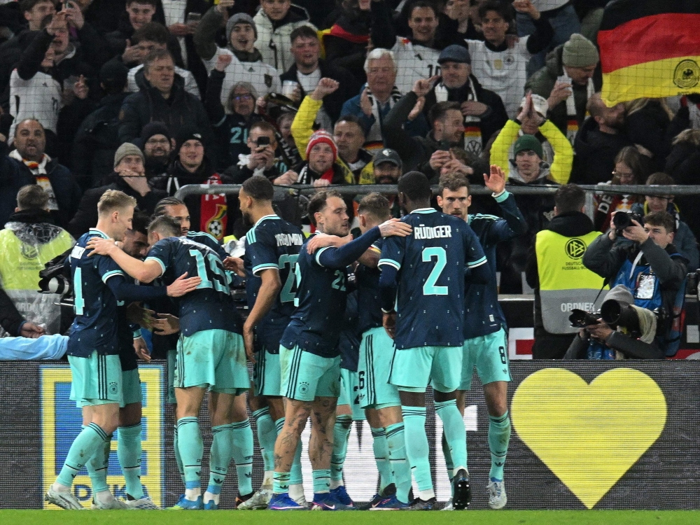  Germany's players celebrate forward #13 Deniz Undav after he scored his team's second goal