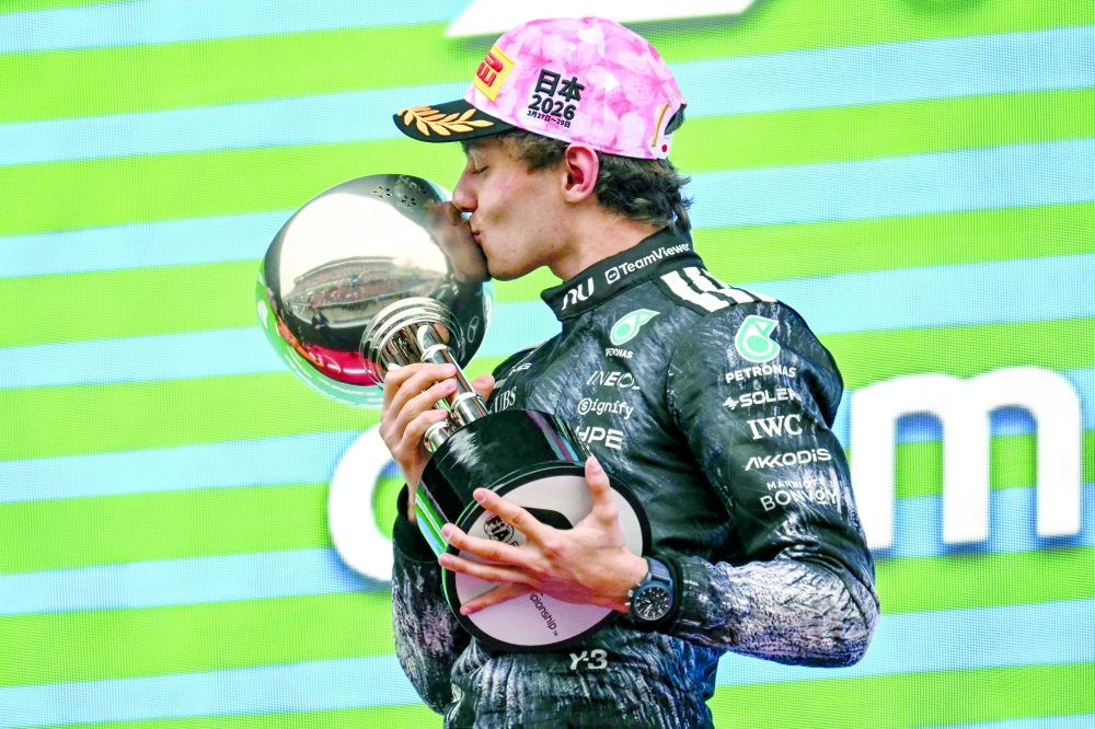 Winner Mercedes' Italian driver Kimi Antonelli celebrates on the podium after the Formula One Japanese Grand Prix at the Suzuka circuit in Suzuka, Mie prefecture on March 29, 2026.  (Photo by Philip FONG / AFP)
