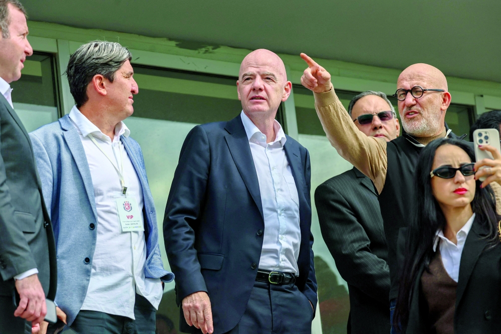 FIFA's President Gianni Infantino (C) arrives to attend a friendly football match between Iran and Costa Rica, in Antalya, southern Turkey, on March 31, 2026. FIFA's president told AFP that Iran "will be at the World Cup" despite the Middle East war. (Photo by Adem ALTAN / AFP)
