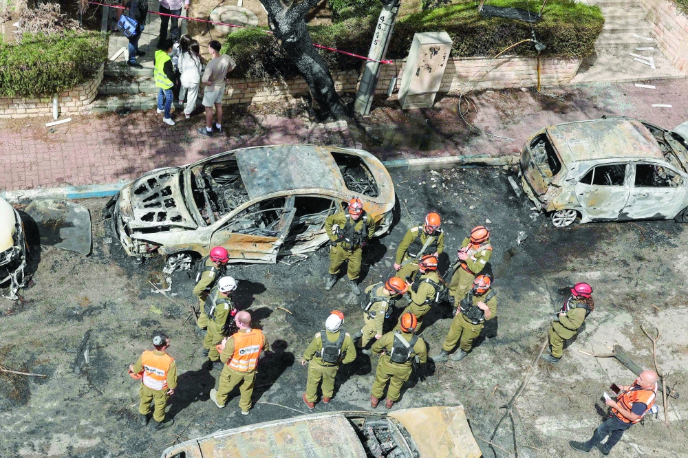 First responders work at a site hit during an Iranian strike over Petah Tikva. — AFP