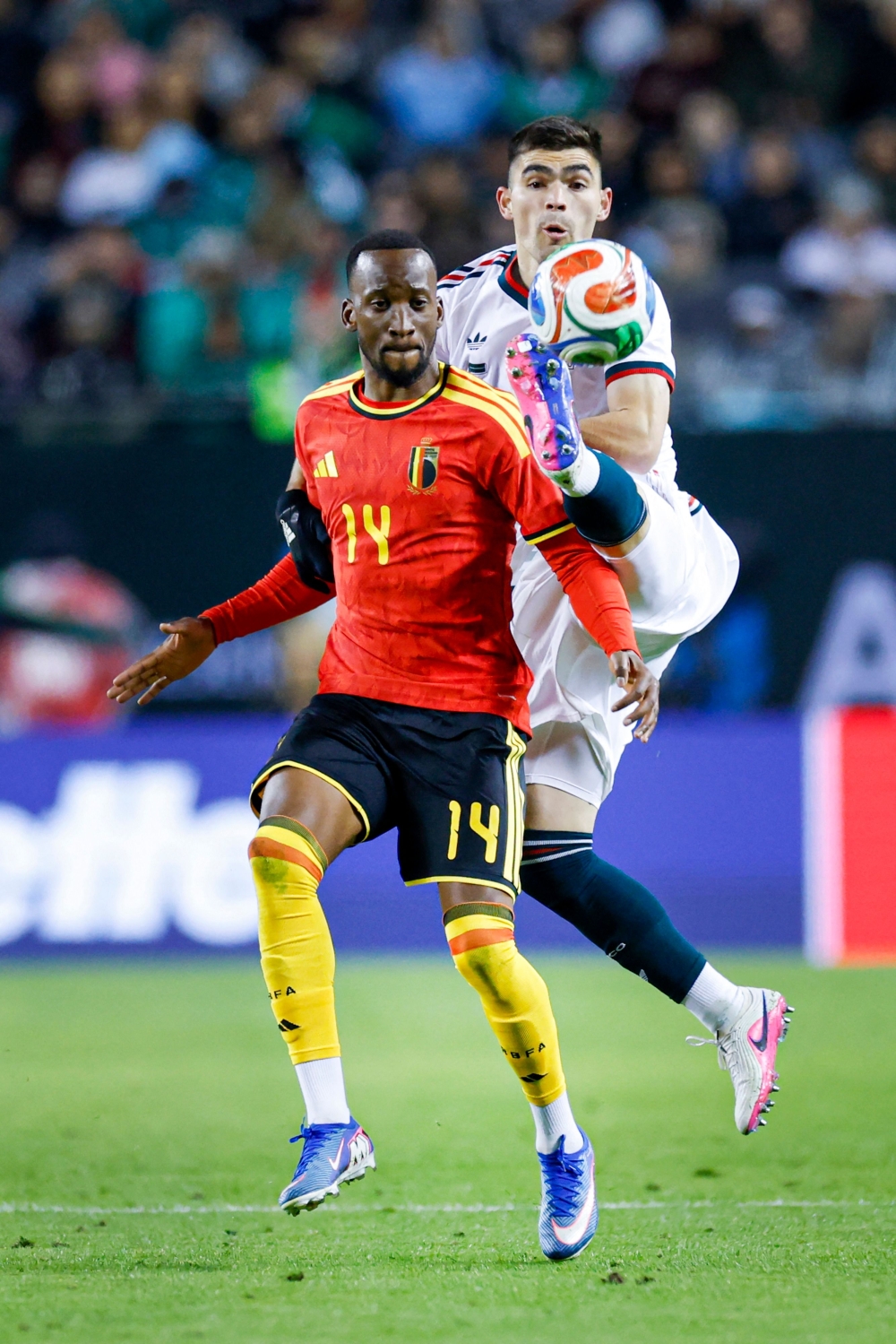 Mexico's defender #05 Johan Vasquez (R) battles for the ball with Belgium's forward #14 Dodi Lukebakio  