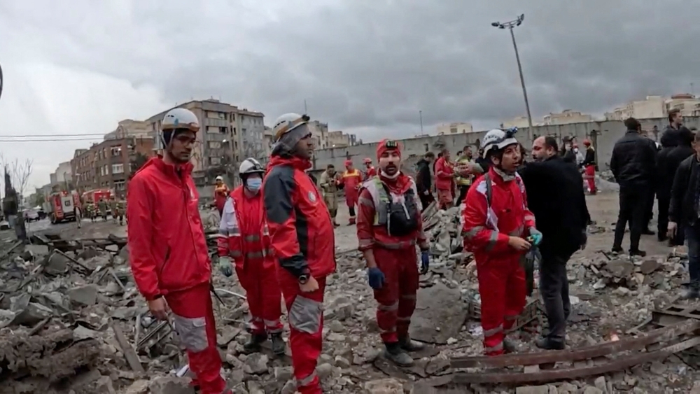 Members of the Iranian Red Crescent Society work at the site of a reported strike, amid the U.S.-Israeli conflict with Iran, in Tehran