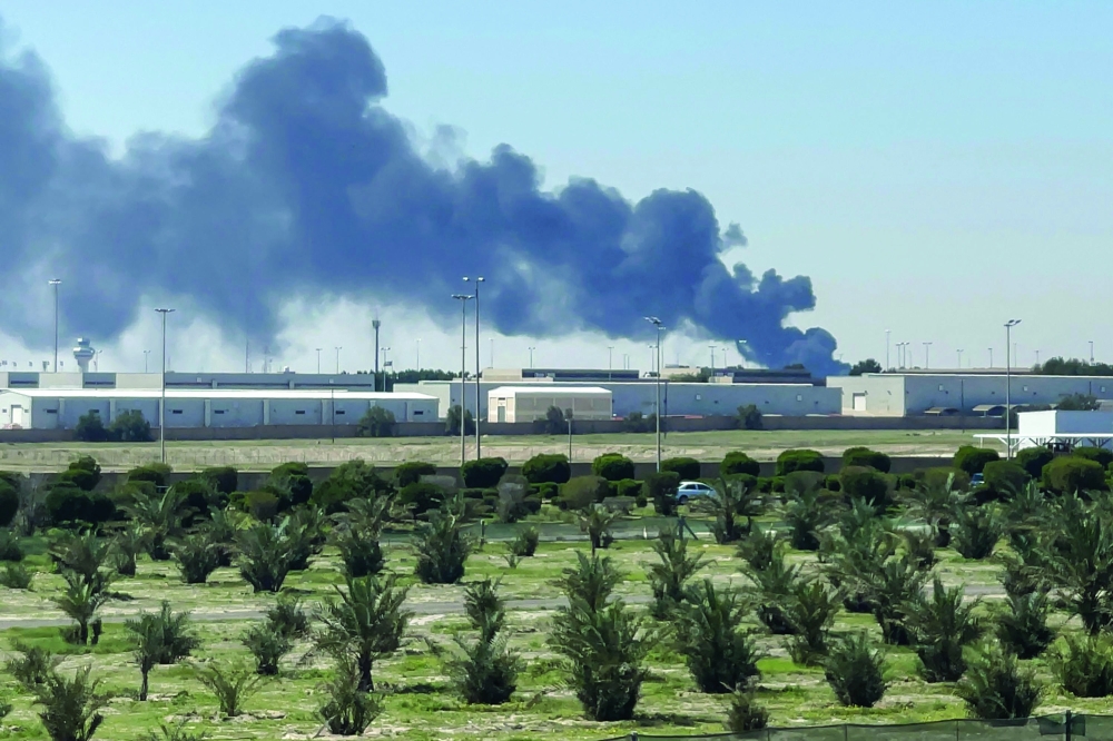 Smoke rises from an area of Kuwait's international airport after a reported drone strike. — AFP