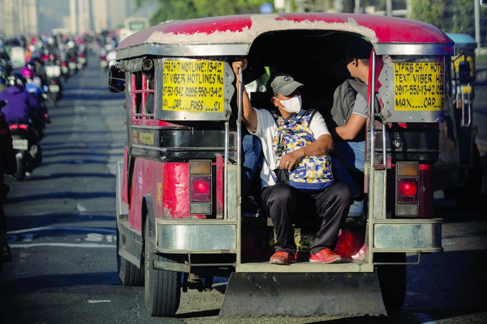 A passenger sits at the back of an overcrowded Jeepney, in Quezon City, Philippines. — Reuters 