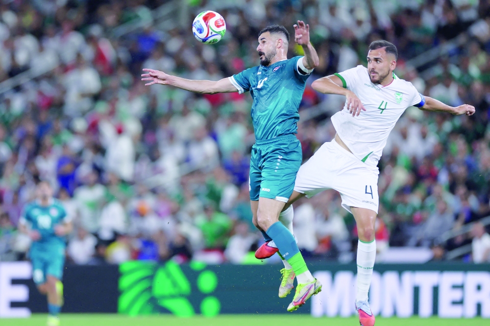 Iraq's forward #18 Aymen Hussein and Bolivia's defender #04 Luis Haquin fight for the ball during the 2026 FIFA World Cup qualifiers final playoff football match between Iraq and Bolivia at the BBVA Stadium in Guadalupe, Nuevo Leon state, Mexico, on March 31, 2026.  (Photo by Julio Cesar AGUILAR / AFP)
