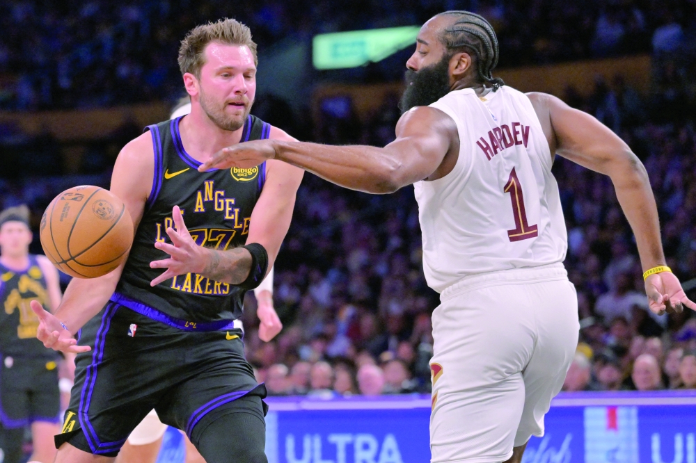 Los Angeles Lakers' Luka Doncic (77) is defended by Cleveland Cavaliers' James Harden (1) as he drives to the basket at Crypto.com Arena. — Imagn Images