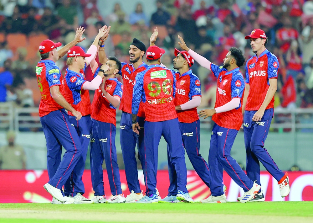 Punjab Kings' Yuzvendra Chahal celebrates with teammates after taking the wicket of Gujarat Titans' Shubman Gill, caught out by Cooper Connolly. — Reuters