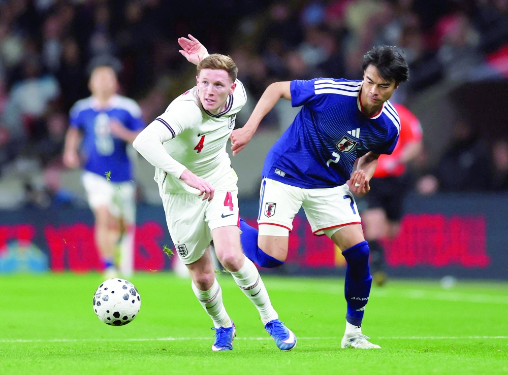 England's Elliot Anderson in action with Japan's Kaoru Mitoma. — Reuters