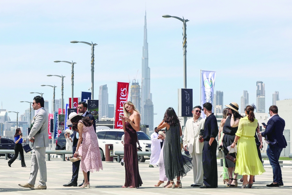 Guests line up to enter Meydan Racecourse to attend the Dubai World Cup horse race in Dubai. - AFP