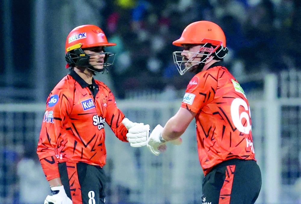 Sunrisers Hyderabad' Travis Head bumps fists with Abhishek Sharma in Kolkata. — Reuters