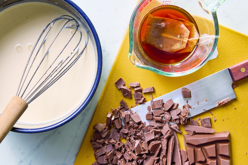 Ingredients for an Earl Grey chocolate tart. Steeping the tea in boiling water, instead of directly into dairy, is a much quicker way to extract flavour.