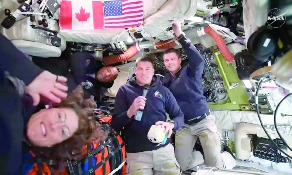 This screen grab from a Nasa live broadcast video shows (L-R) astronauts during a press call as they travel to the Moon in the Orion spacecraft on Friday. — AFP