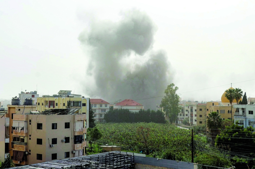 A smoke cloud erupts following Israeli bombardment on Abbasiyeh, near Tyre in southern Lebanon. — AFP 