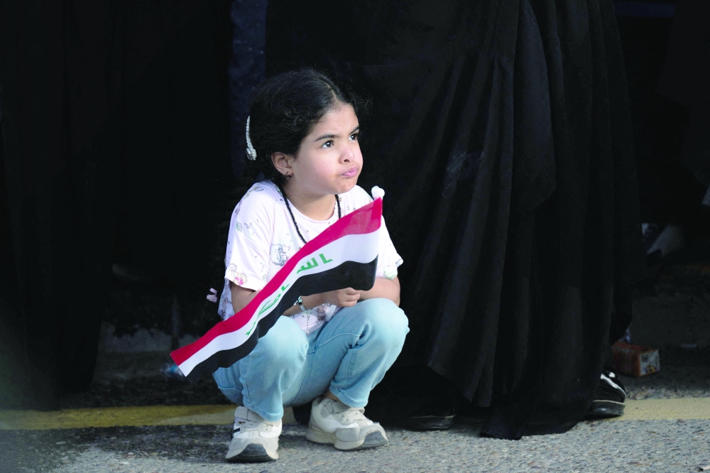 A girl looks on during a demonstration in solidarity with Iran and denouncing the US-Israeli war against it, in Iraq's southern city of Basra, on Saturday. — AFP