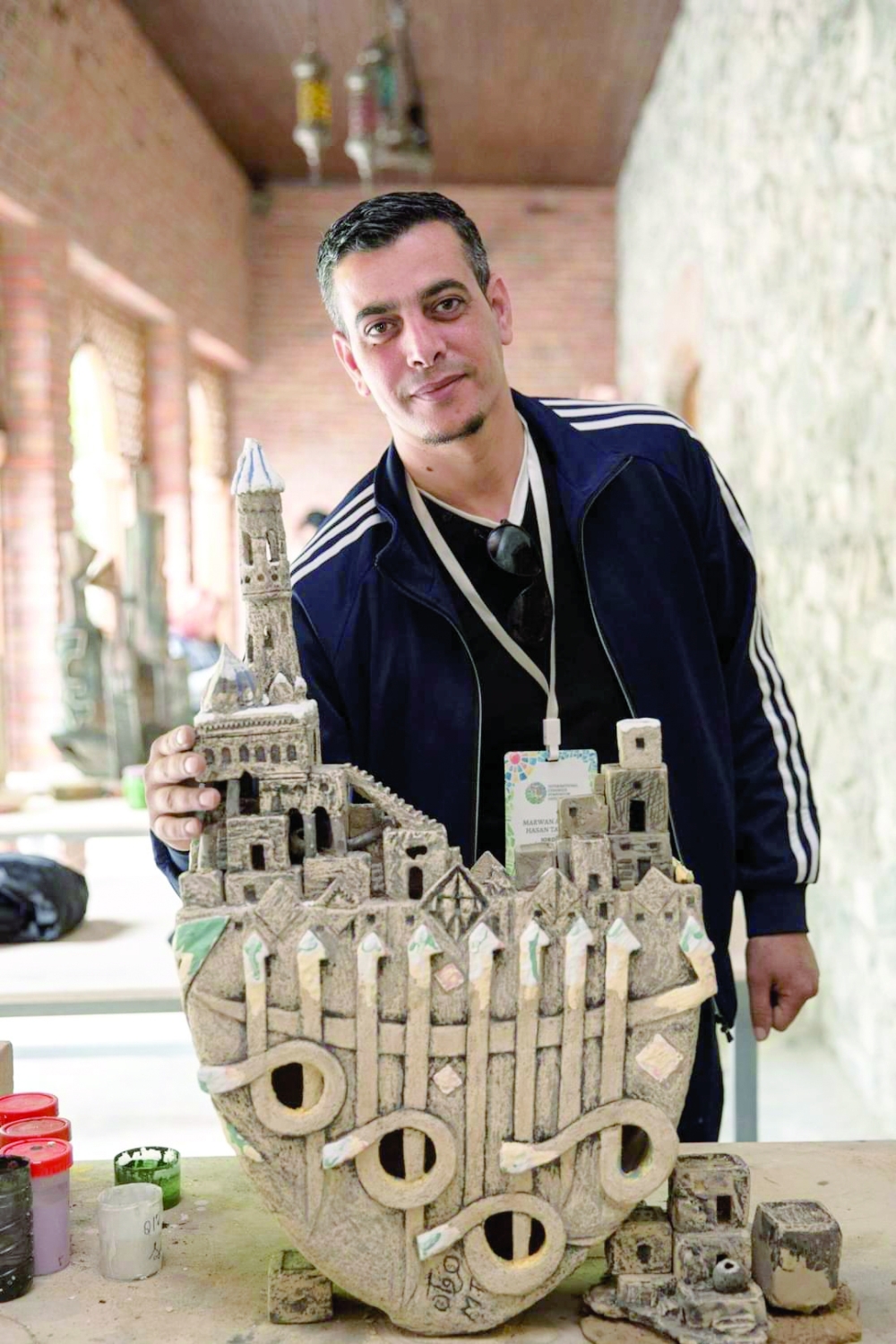 Jordanian artist Marwan al Tawaha with his work