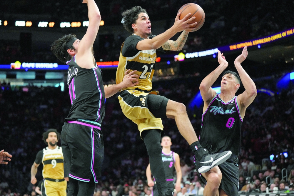 Washington Wizards guard Will Riley drives to the basket as Miami Heat forward Simone Fontecchio and forward Jaime Jaquez Jr. — Imagn Images