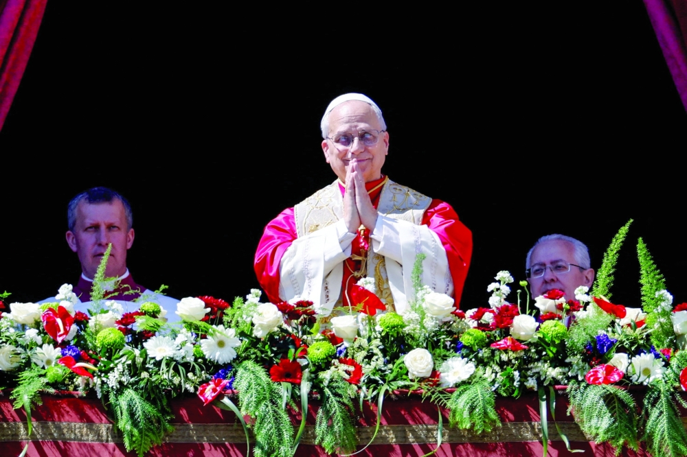 Pope Leo XIV gestures from the main balcony of St. Peter's Basilica, at the Vatican. — Reuters