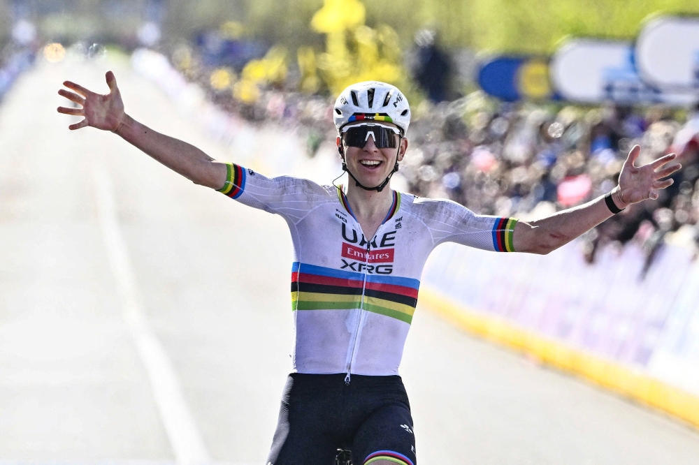 UAE Team Emirates  Slovenian rider Tadej Pogacar celebrates as he crosses the finish line 