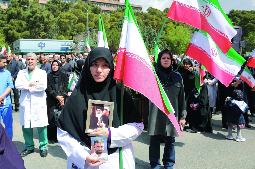Healthcare workers gather for a rally condemning attacks on health facilities by the US and Israel outside at Imam Khomeini Hospital in Tehran on Monday. — AFP 