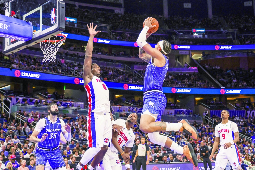 Orlando Magic's Paolo Banchero (5) shoots against Detroit Pistons' Jalen Duren (0) at Kia Center. — Imagn Images