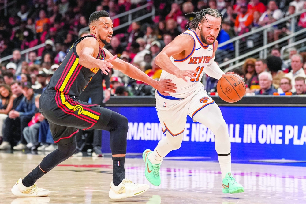 New York Knicks' Jalen Brunson (11) dribbles against Atlanta Hawks' CJ McCollum (3) at State Farm Arena. — Imagn Images