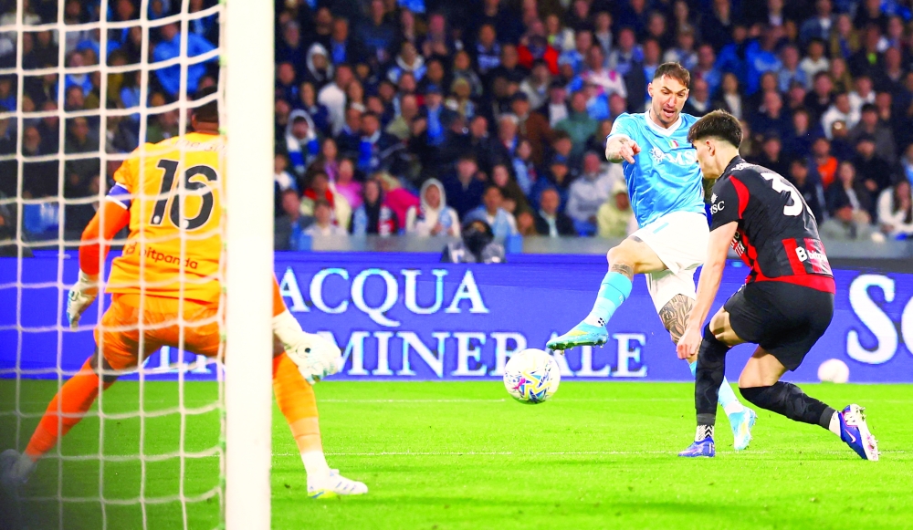 Napoli's Matteo Politano scores their first goal against AC Milan in Naples, Italy. — Reuters